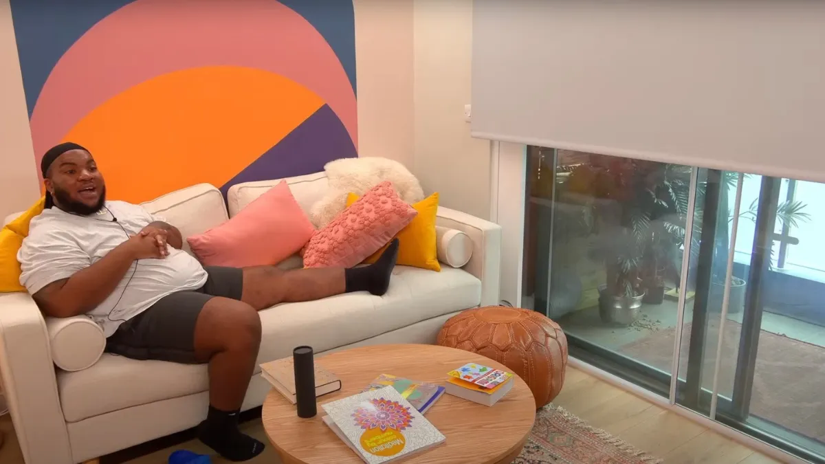 The Circle contestant sitting on a couch