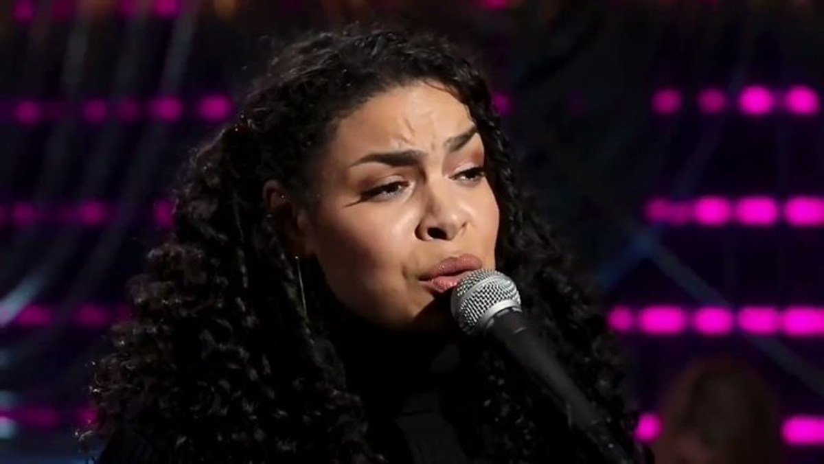 Jordin Sparks, singing in front of a microphone. 