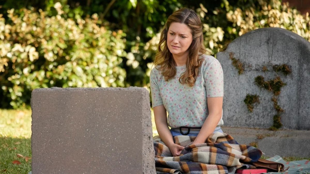 Mary Cooper looking at a grave. This image is part of an article about when Young Sheldon Season 7 is coming to Netflix.