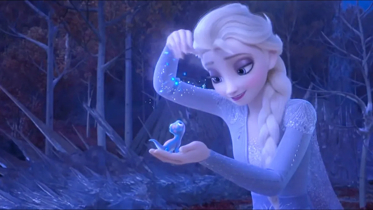 Elsa sprinkles ice particles on a critter in frozen 2