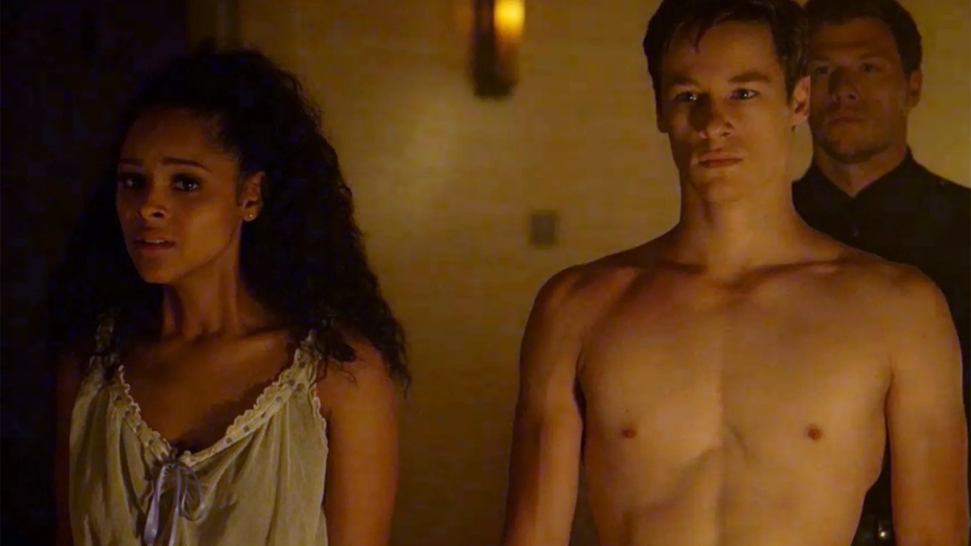 Two people stand in their undergarments