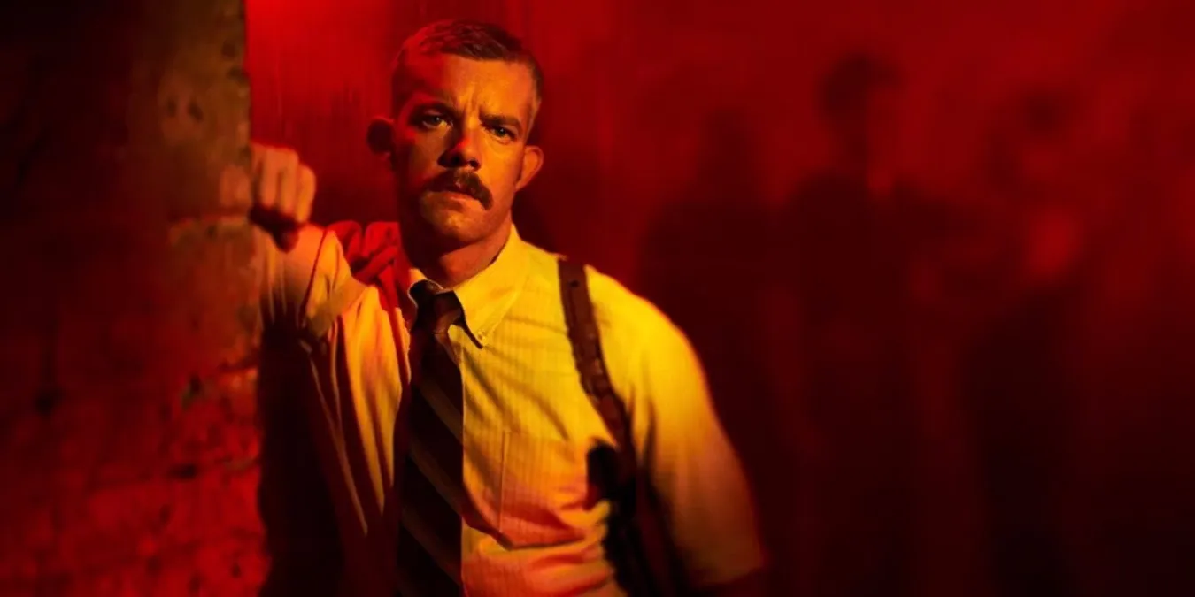 Detective Patrick Reed stands in red light