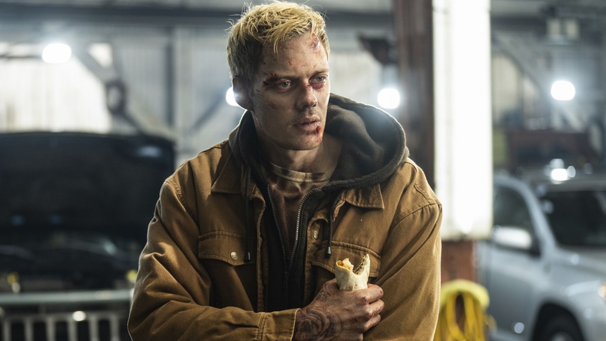Bill Skarsgard as Eddie holding a burrito in Locked