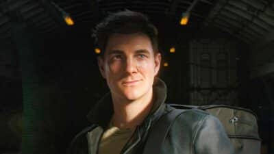 A person dressed in a leather jacket stands inside a dimly lit airplane. A backpack rests beside them, hinting at travel.