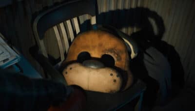 Close-up of the Freddy Fazbear mask resting on a chair in the FNAF 2 trailer