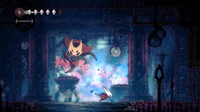 In a vibrant, mystical cave, two insect-like figures engage in battle. The left character leaps with a weapon, while the right charges forward. Tense atmosphere.