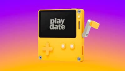The yellow Playdate handheld with crank extended against a gradient background