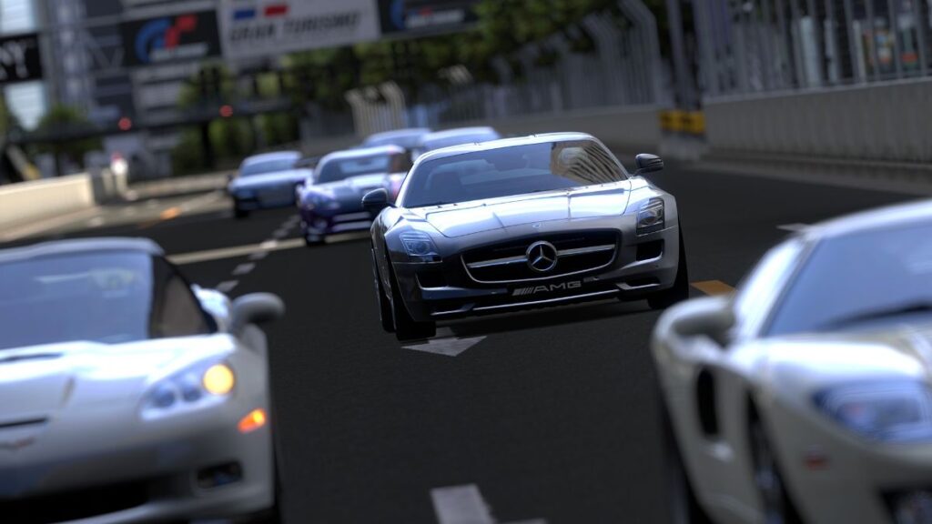 A silver Mercedes-AMG races down a track in Gran Turismo with other cars in pursuit