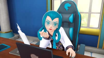 Female character with teal hair and glasses sitting at a desk in Pokémon Legends Z-A