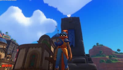 A character in an orange outfit stands in a colorful town beneath a clear blue sky, with clouds and distant hills visible