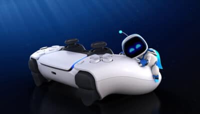 Small robot leaning on a PlayStation 5 DualSense controller against a dark blue background