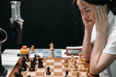 A woman plays Chess against a robot
