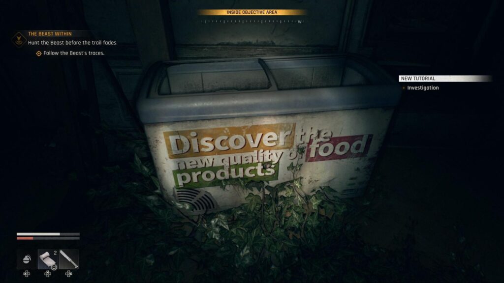 Old freezer with faded food ad overgrown by plants