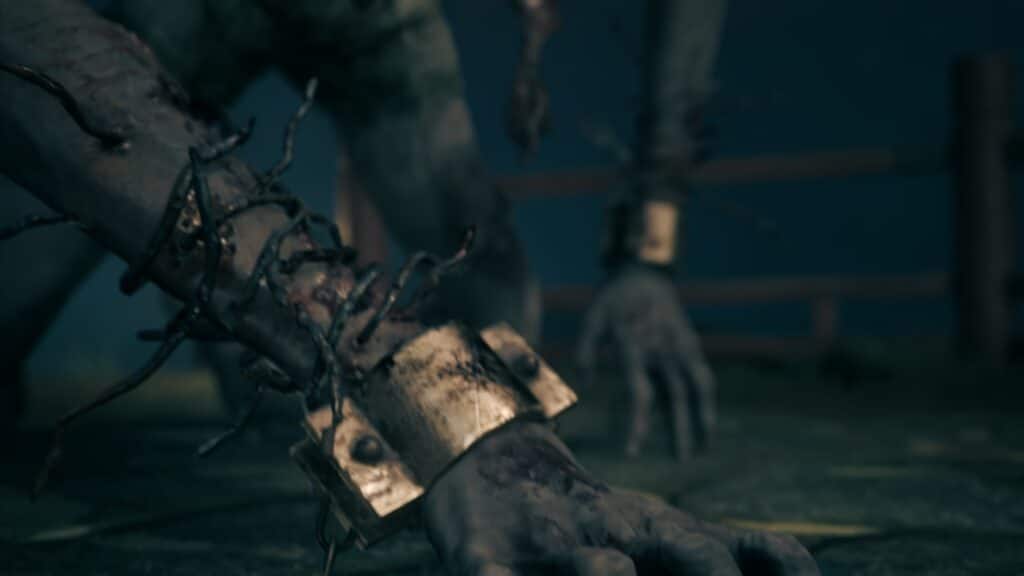 Close-up of a grotesque monster’s chained, bloodied arm in Silent Hill f