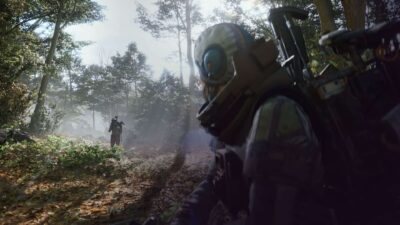 Arc Raiders characters in helmets and gear exploring a misty forest with sunlight breaking through the trees.