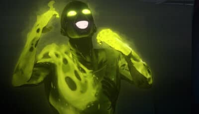 A glowing figure emits a vibrant green light, with luminous eyes and an open mouth in Dispatch