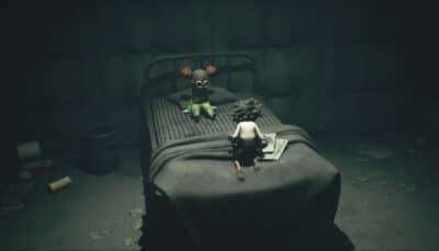 Low sitting on a bed across from Alone, his doll-like companion, in Little Nightmares 3’s final chapter