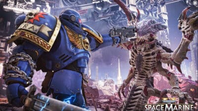 Pictur of an Warhmmaer 40,000 Ultramarine holding a Tyranid creature by its neck.