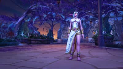 Picture of a night elf from world of warcraft wearing the Azshara transmog, which is a white dress with part of it dangling over the right leg