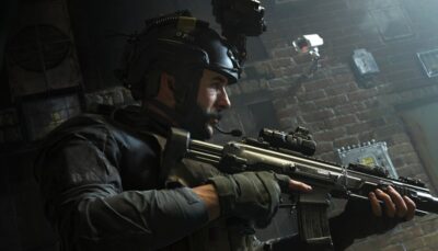 A tactical operator sweeps a dimly lit room with his rifle in Call of Duty: Modern Warfare, ready for close-quarters combat.
