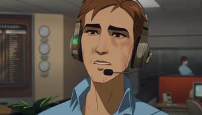A concerned operator wearing a headset in the call-center office during a tense moment in Dispatch
