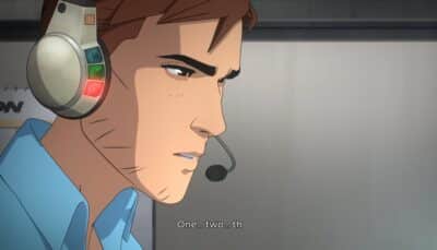 An animated man wearing a headset with indicator lights focuses intensely while counting, saying “One… two… th,” during a tense scene in the show Dispatch.