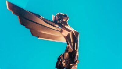 Close-up view of The Game Awards trophy with its stylized winged figure against a bright blue background
