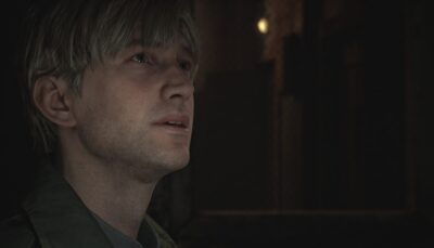 Close-up of James Sunderland looking upward in a dimly lit hallway in the Silent Hill 2 remake
