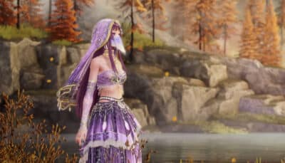 Nikki in an elaborate, purple costume with a veil stands by a serene lake