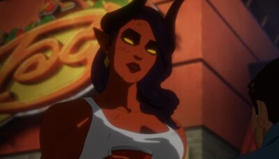 An animated demon woman with glowing yellow eyes and curved horns standing outdoors, holding a cup and looking down at someone off-screen