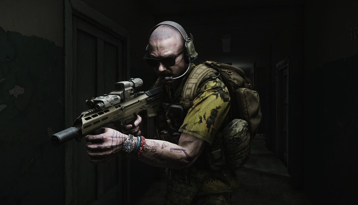 A heavily armed operator clears a dark corridor during a raid in Escape from Tarkov