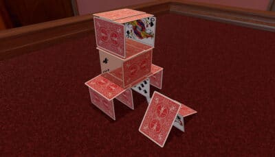 Tabletop Simulator shows a carefully stacked house of playing cards standing on a red carpet