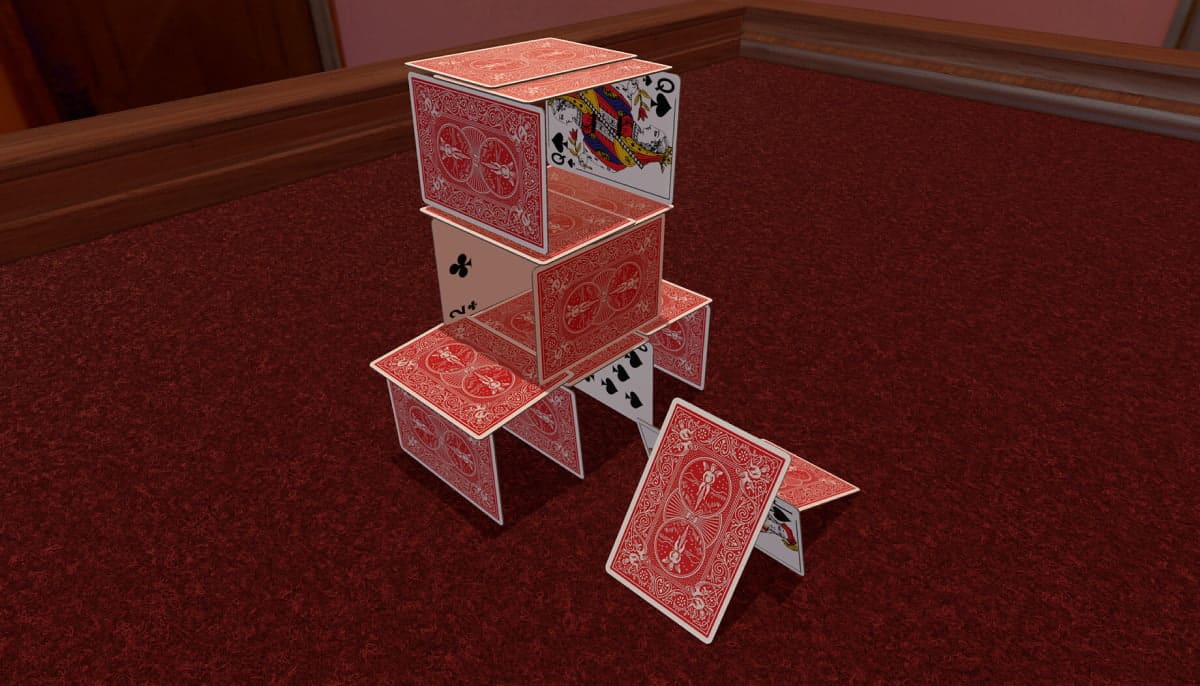 Tabletop Simulator shows a carefully stacked house of playing cards standing on a red carpet