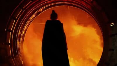 A cloaked silhouette stands before a blazing circular gateway in Star Wars Fate of the Old Republic
