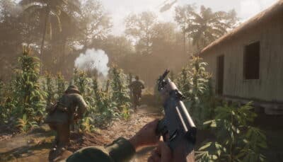 Soldiers advancing through a village path as an explosion goes off in Hell Let Loose: Vietnam