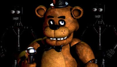 Freddy Fazbear holds a microphone under dim lighting in a Roblox horror experience