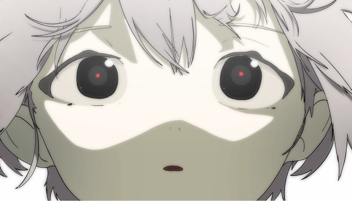 A child stares ahead with glowing eyes in Children’s Garden as soft light washes over their face