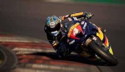 RIDE 6 motorcycle racer leaning into a high-speed asphalt corner during a professional circuit race