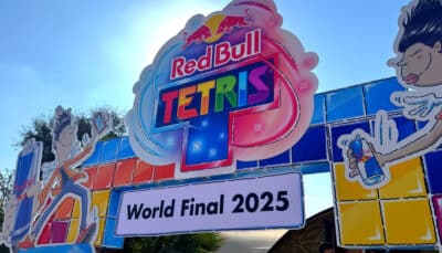 A colorful Red Bull Tetris World Final 2025 entrance sign stands outdoors against a bright sky