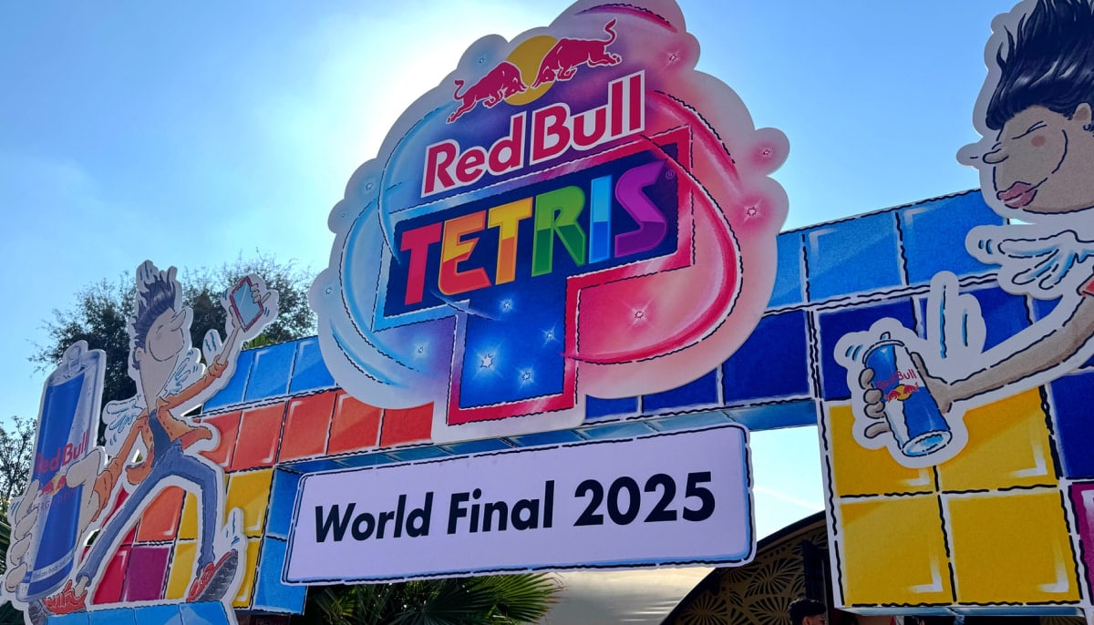 A colorful Red Bull Tetris World Final 2025 entrance sign stands outdoors against a bright sky