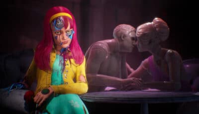 A damaged girl with bright pink hair sits on a couch in Judas, her mechanical eye exposed. Behind her, two mannequin like figures lean in for a kiss at a dimly lit table