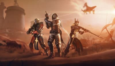 Three armored Guardians move forward with weapons ready as the sun sets over a hostile landscape in Destiny 2