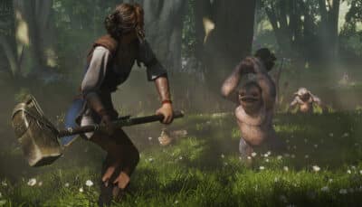 A hero in Fable swings a large hammer at small creatures attacking in a sunlit forest