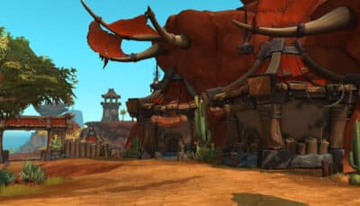 An orc style settlement with massive tusks wooden buildings and desert surroundings in World of Warcraft