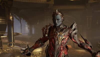 A Warframe wearing ornate red and gold armor stands with arms open in an elegant interior