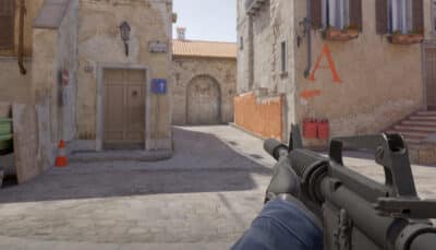 Counter-Strike 2 first-person view aiming down a narrow street toward the A site