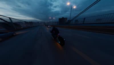 Motorcycle riding on an open highway at night in Lanesplit