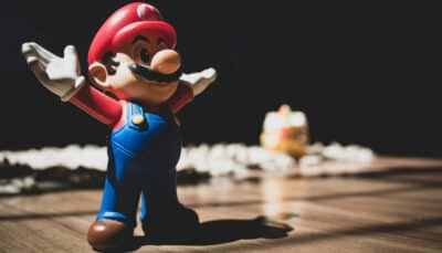 Super Mario figurine with raised arms, reflecting the excitement around the Nintendo Direct Partner Showcase