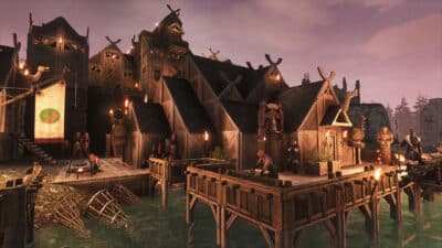 A large wooden settlement built over water in Conan Exiles, with Viking-style buildings, docks, torches, and NPC characters walking around the base.
