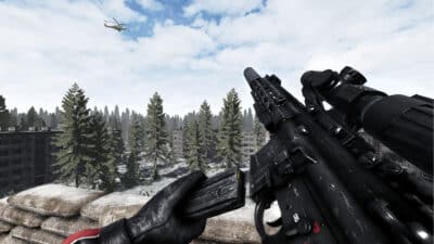 Image of a marine on top of an eastern european urban space, overwatching with an assault rifle.